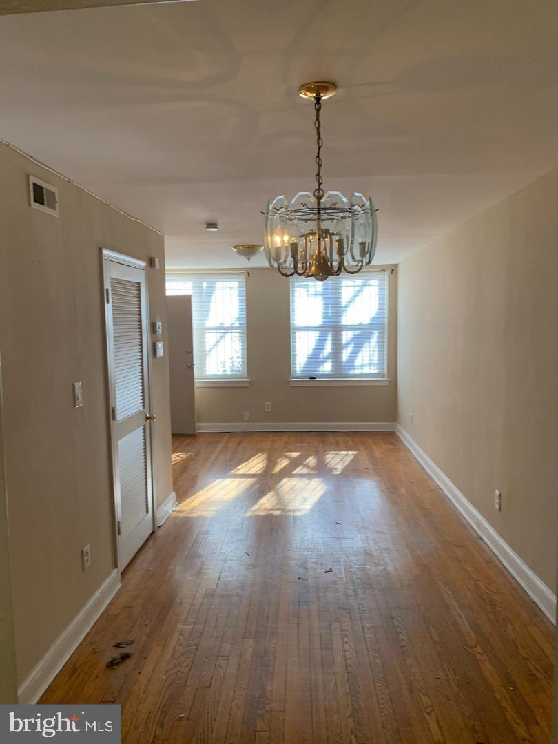 141 Galveston Place Southwest Washington, DC 20032 - Photo 8 of 27 a view of a room with wooden floor chandeliers and kitchen