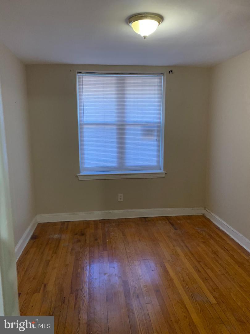 141 Galveston Place Southwest Washington, DC 20032 - Photo 10 of 27 an empty room with wooden floor and windows