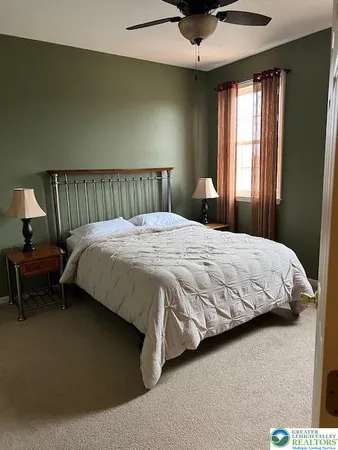 a bedroom with a bed and window