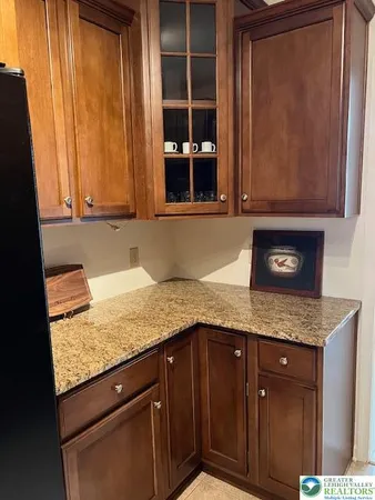 a kitchen with granite countertop cabinets and window