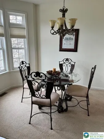 a dining room with furniture and window