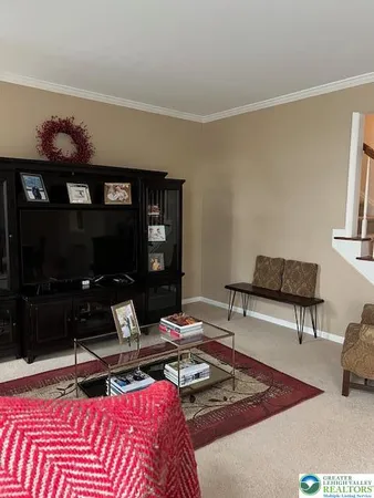 a living room with furniture a rug and a fireplace
