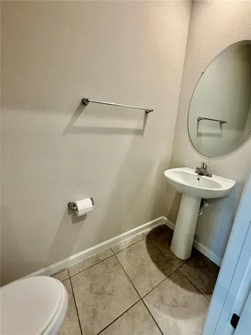 a bathroom with a sink toilet and a mirror