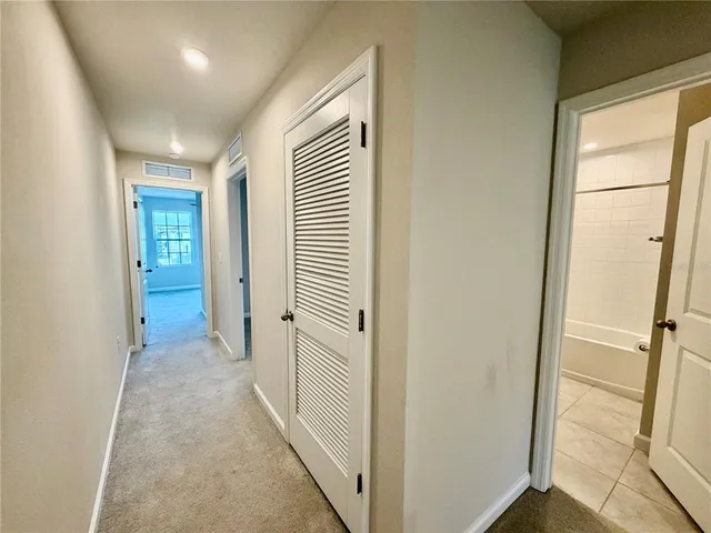 a view of a hallway with wooden floor and entryway