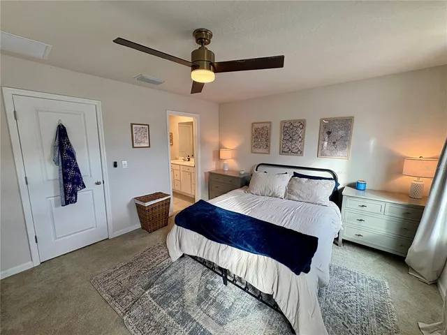 a bedroom with a bed and a painting on the wall