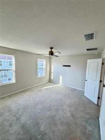 an empty room with windows and closet