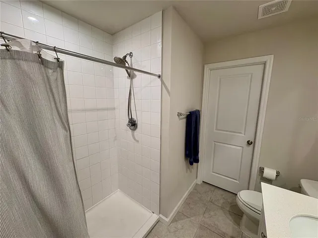 a bathroom with a shower and toilet