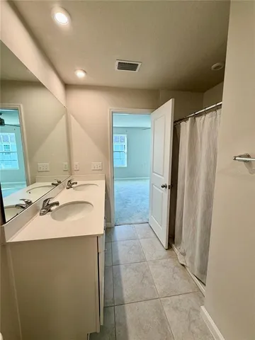a bathroom with a sink toilet and a mirror