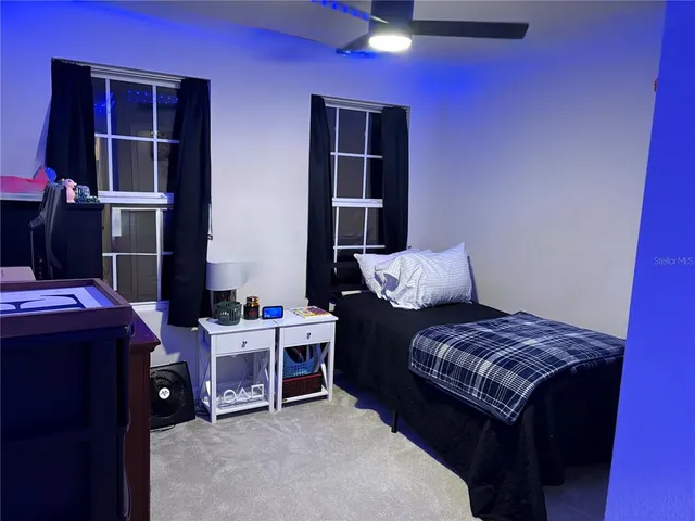 a bedroom with furniture and a closet