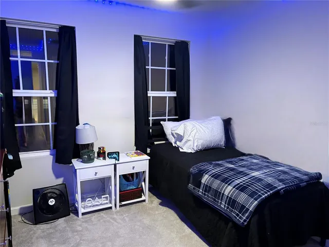 a bedroom with a bed and a bookshelf