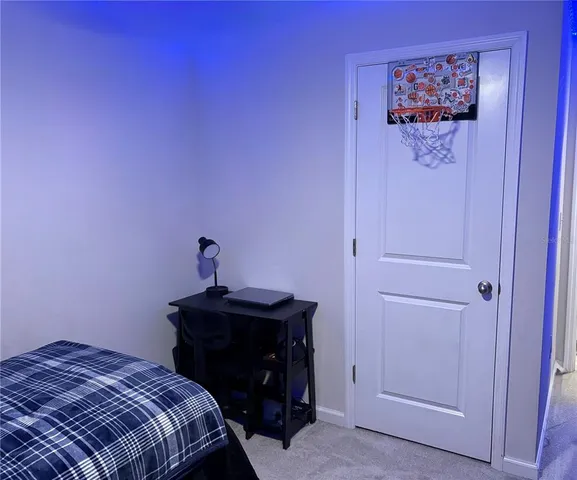 a bedroom with a bed and a mirror