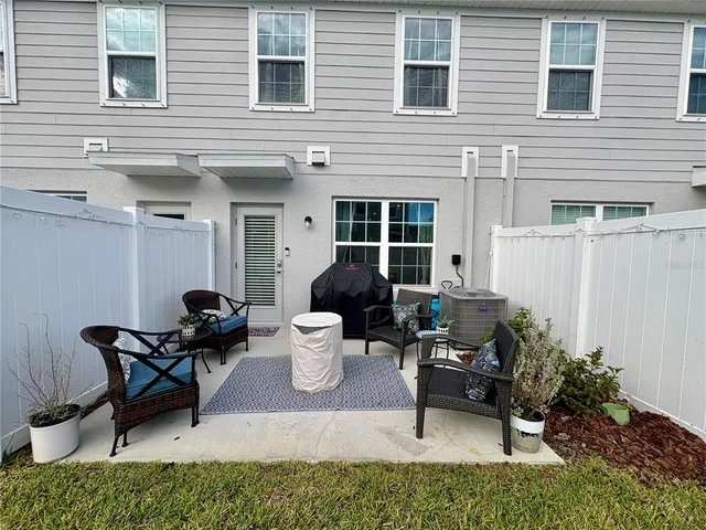 a view of a patio with table and chairs and potted plants