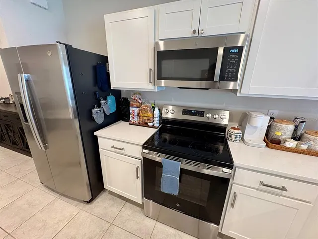 a kitchen with a stove microwave and refrigerator