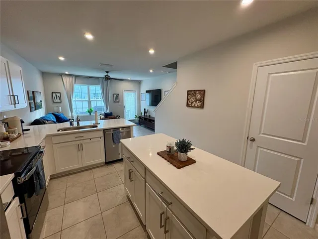a kitchen that has a sink and a stove in it
