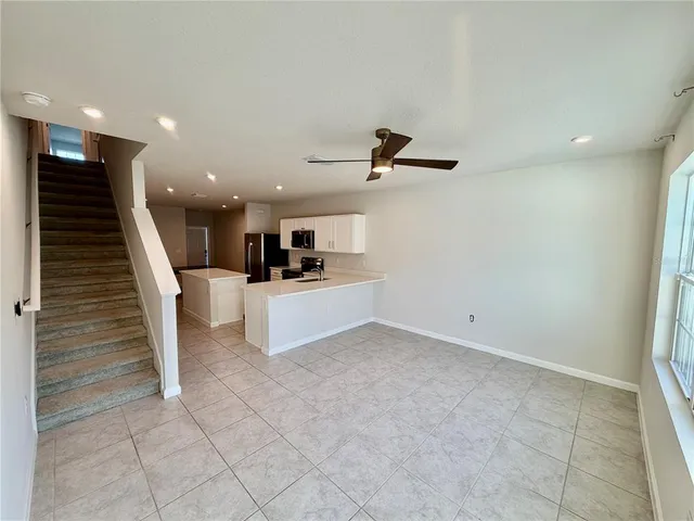 a view of kitchen with appliances and stairs
