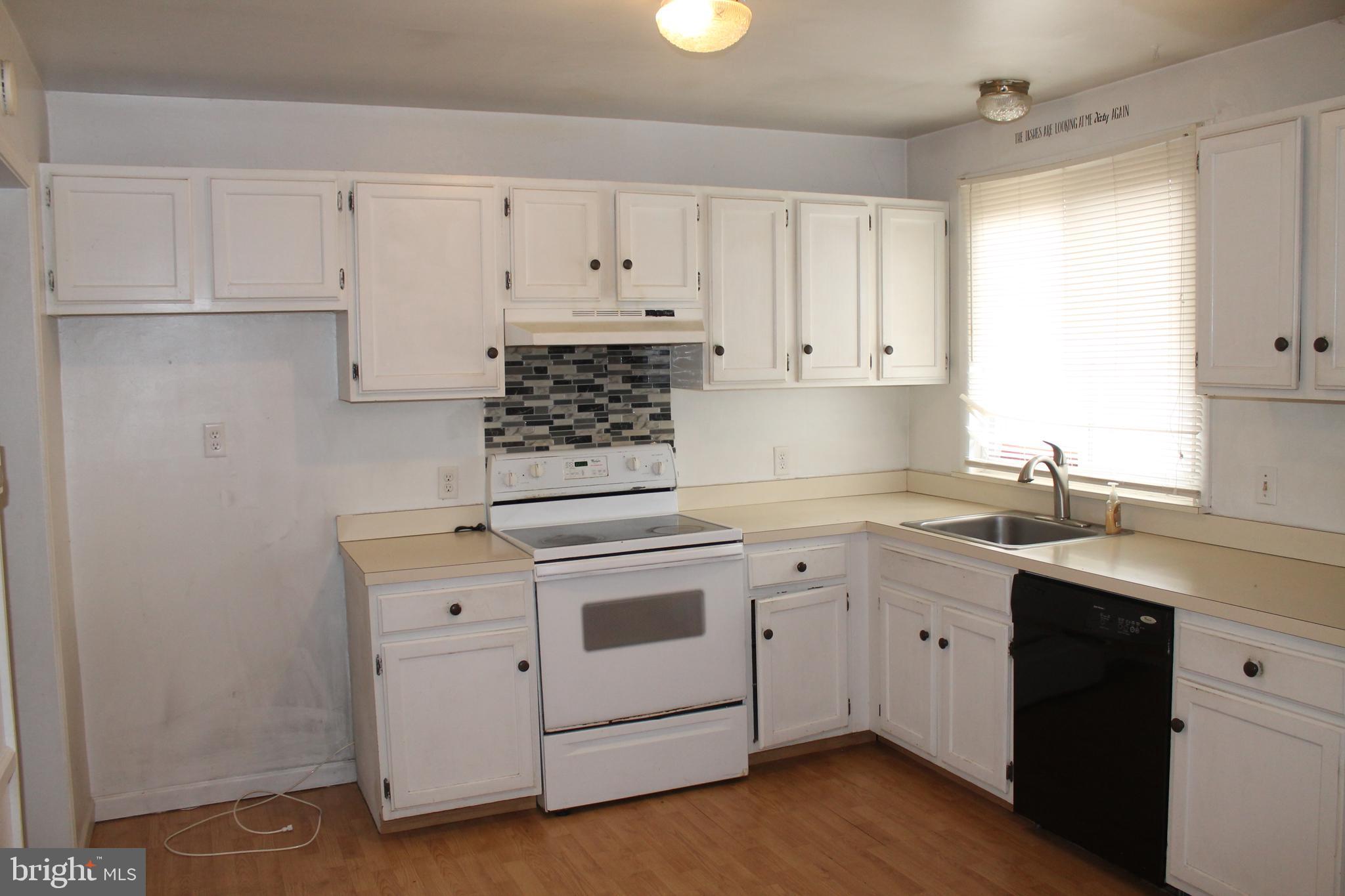 182 Warren Way Lancaster, PA 17601 - Photo 2 of 18 a kitchen with white cabinets stainless steel appliances and sink