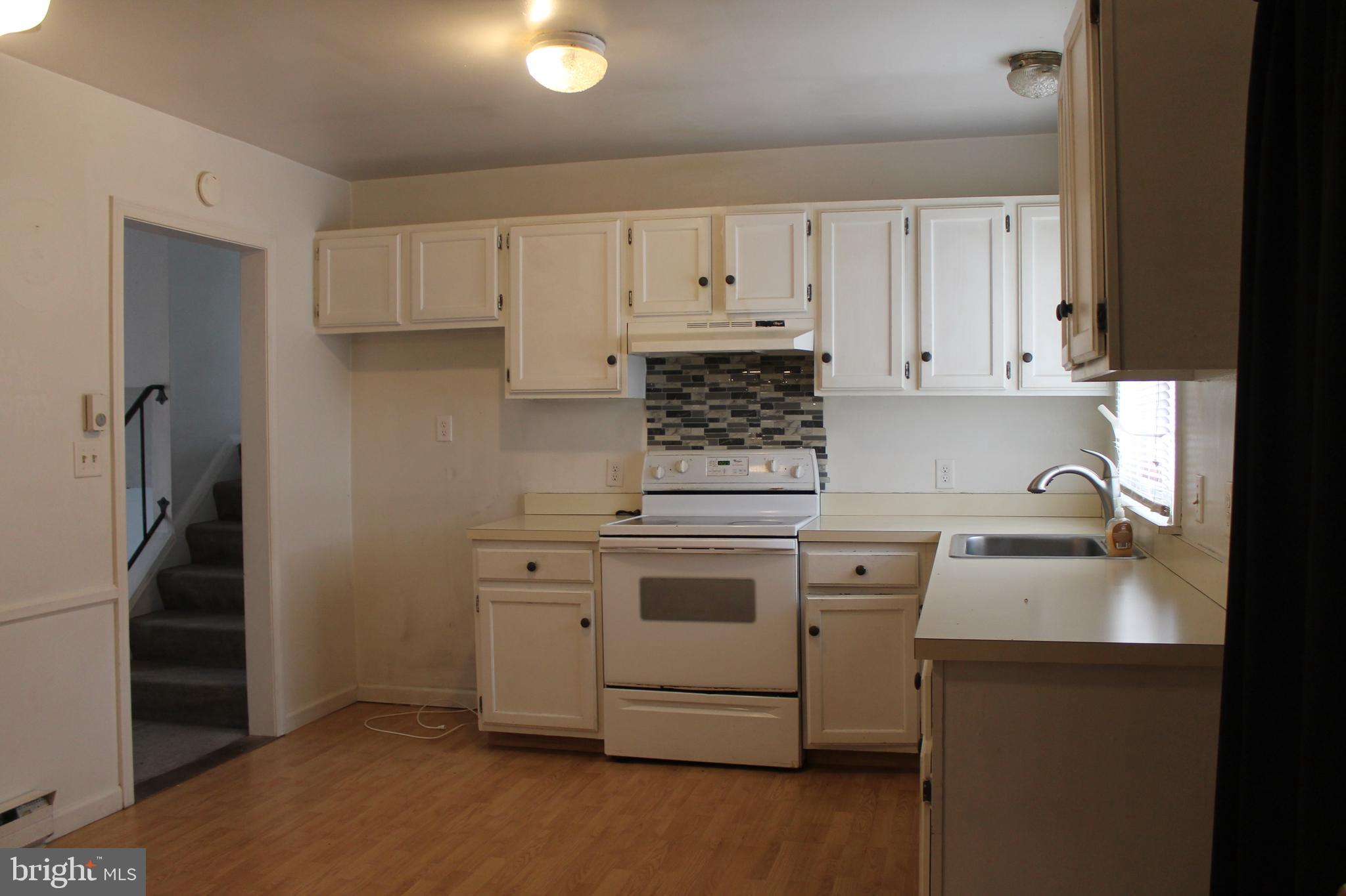 182 Warren Way Lancaster, PA 17601 - Photo 3 of 18 a kitchen with white cabinets and stainless steel appliances