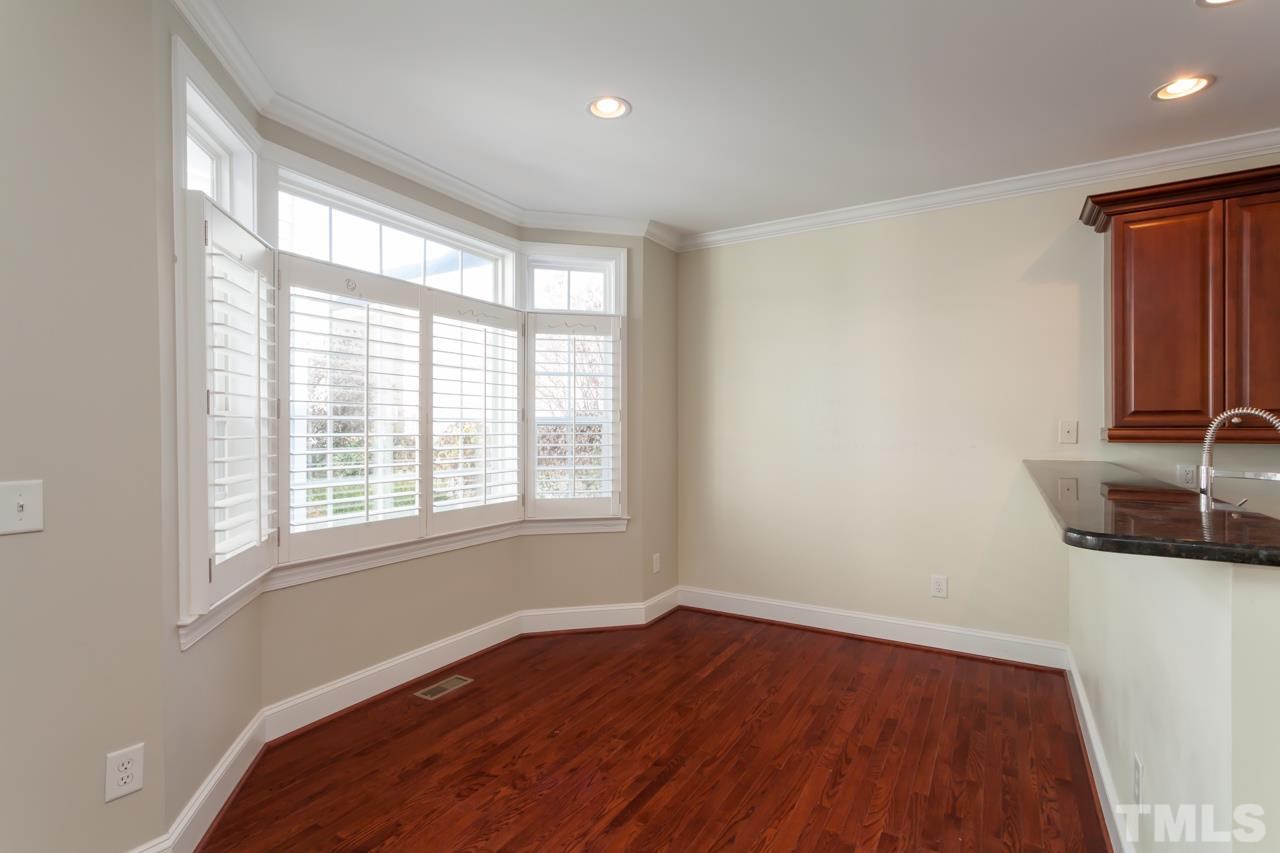 1232 Harp Street Raleigh, NC 27604 - Photo 12 of 25 an empty room with wooden floor and windows