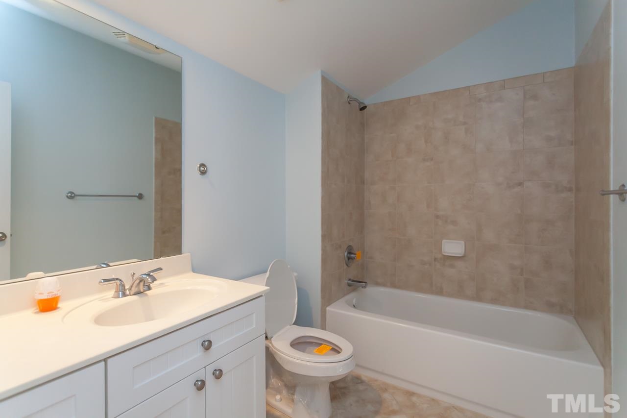 1232 Harp Street Raleigh, NC 27604 - Photo 16 of 25 a bathroom with a sink a toilet and a bathtub