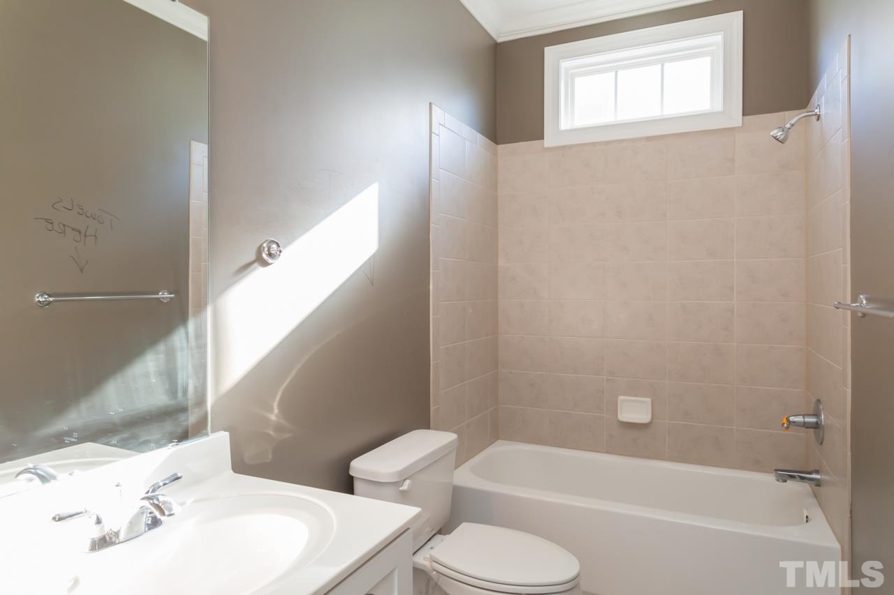 1232 Harp Street Raleigh, NC 27604 - Photo 18 of 25 a bathroom with a sink toilet and shower