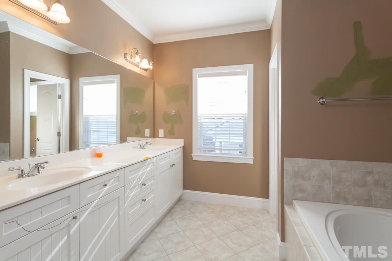 1232 Harp Street Raleigh, NC 27604 - Photo 20 of 25 a bathroom with a double vanity sink a toilet and a tub