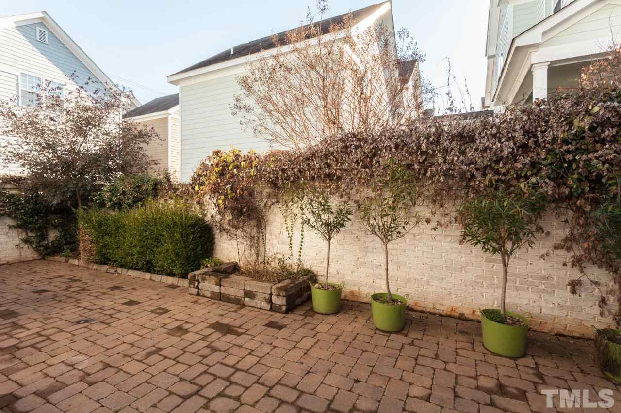1232 Harp Street Raleigh, NC 27604 - Photo 3 of 25 a view of a backyard with plants and chairs