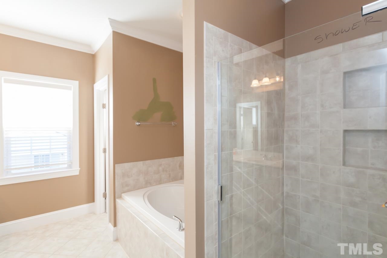 1232 Harp Street Raleigh, NC 27604 - Photo 21 of 25 a bathroom with a tub shower and sink
