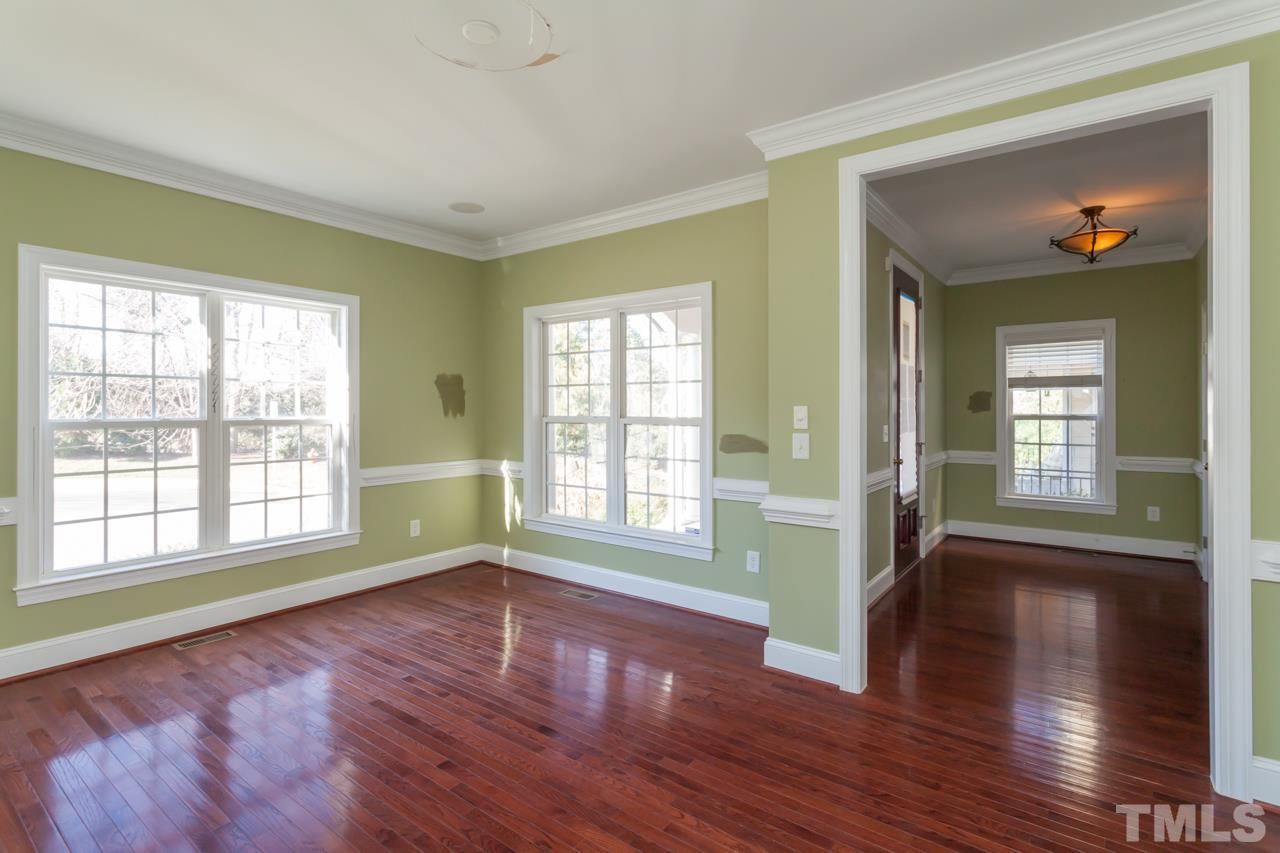 1232 Harp Street Raleigh, NC 27604 - Photo 8 of 25 a view of an empty room with wooden floor and a window