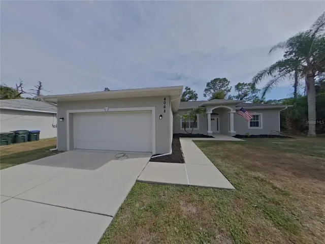 a front view of a house with a yard and a garage