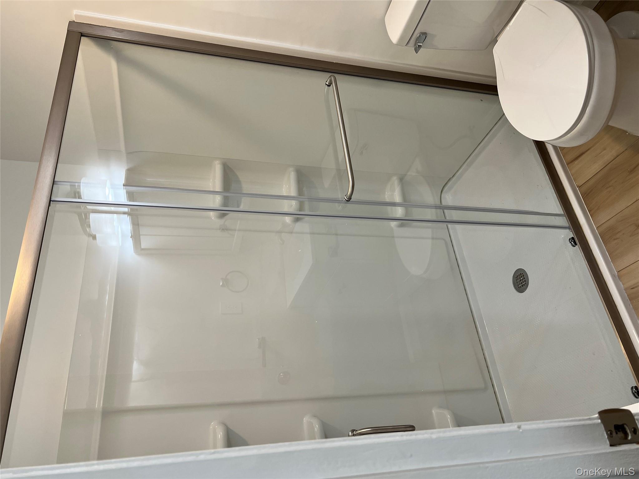 39 B South Norwood Road, Unit RIGHT Port Washington, NY 11050 - Photo 18 of 18 a bathroom with a shower and a toilet