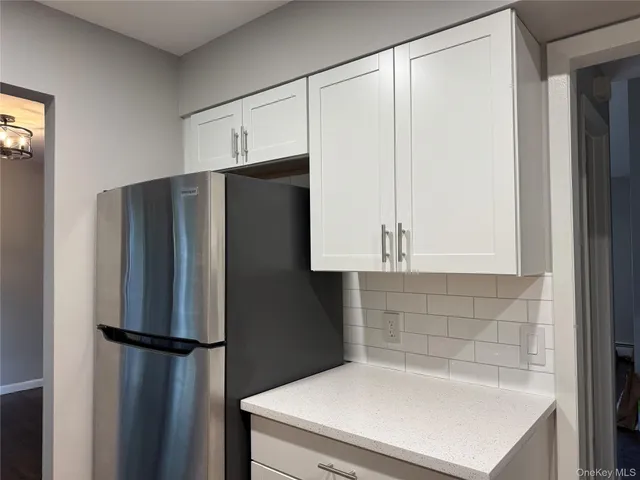 a white refrigerator freezer sitting inside of a kitchen