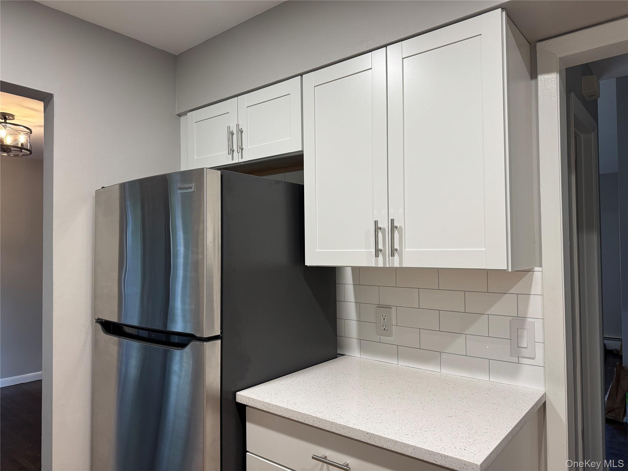 39 B South Norwood Road, Unit RIGHT Port Washington, NY 11050 - Photo 9 of 18 a white refrigerator freezer sitting inside of a kitchen