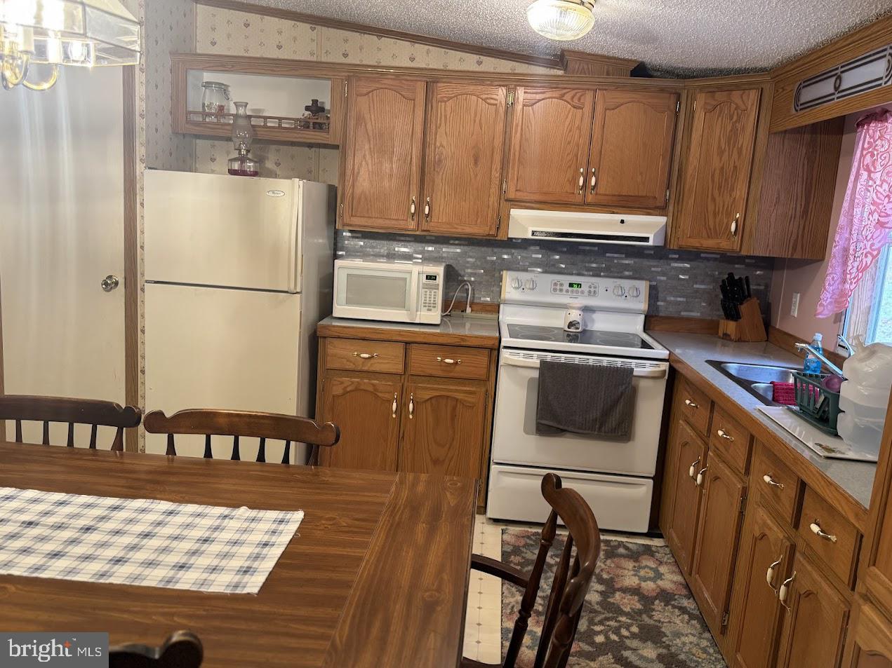 98 Bear Run Road Oakland, MD 21550 - Photo 16 of 28 a kitchen with a refrigerator a stove a sink and cabinets