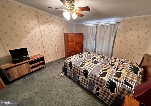 a bedroom with a bed and a television