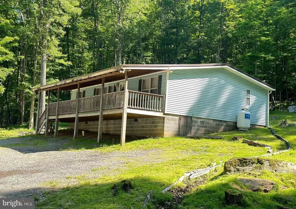 a view of a house with a yard and sitting area