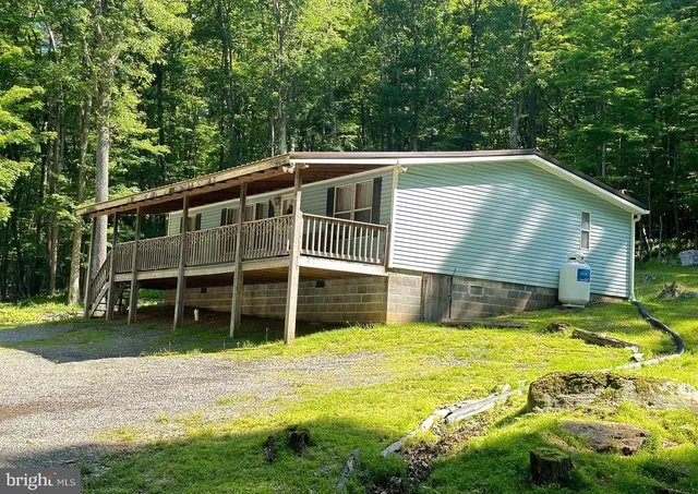 a view of a house with a yard and sitting area