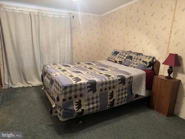 a bedroom with a bed table and curtain