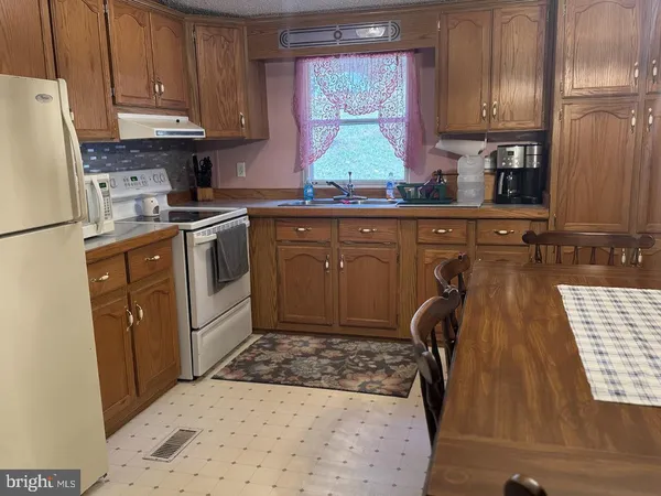 a kitchen with a refrigerator and a sink