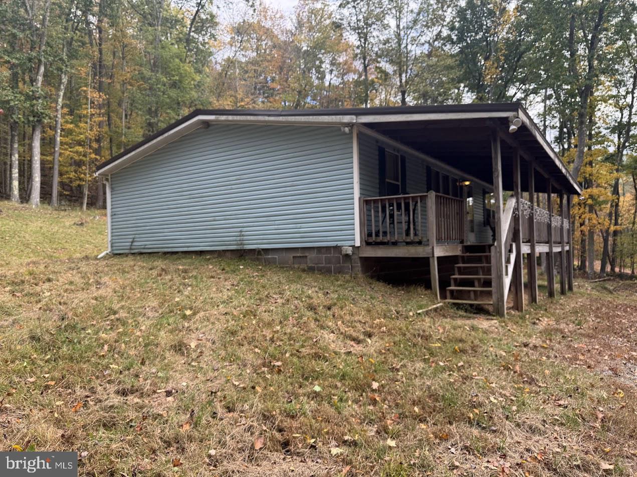 98 Bear Run Road Oakland, MD 21550 - Photo 3 of 28 a backyard of a house with barbeque oven and trees
