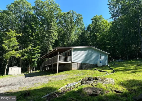 a house with a big yard and large trees