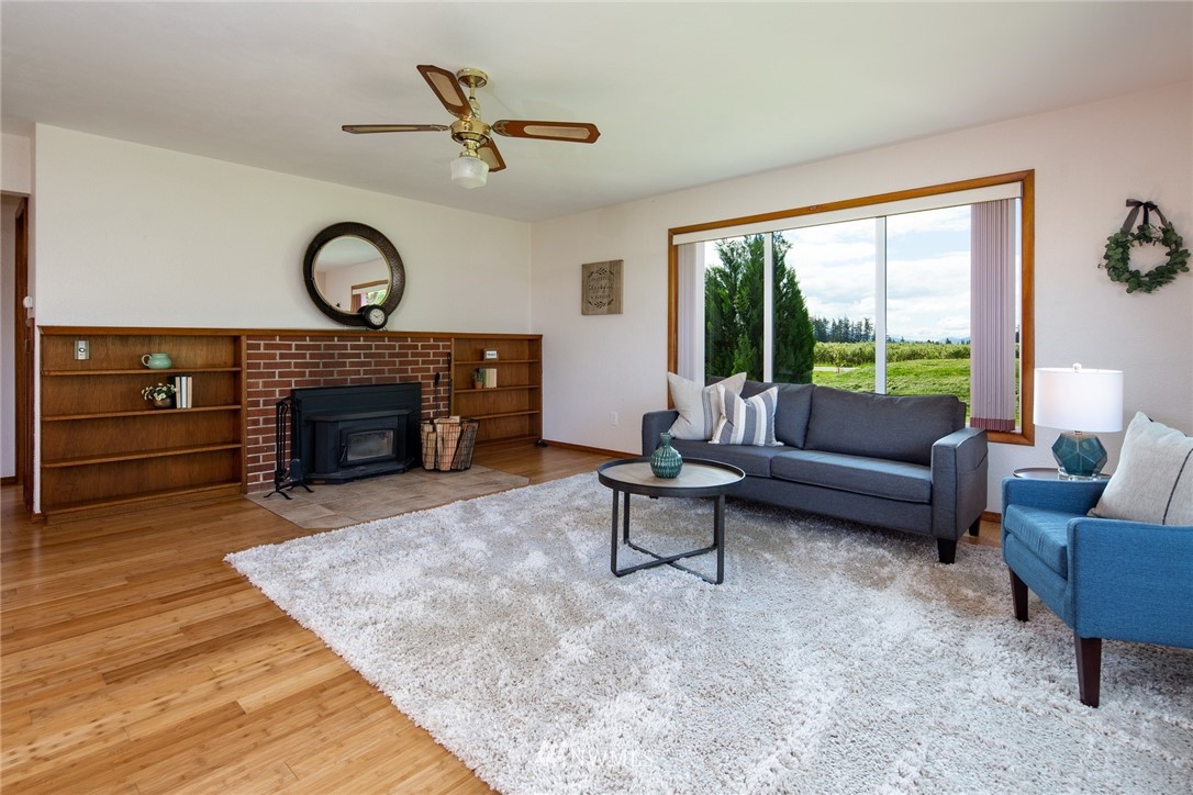 1506 Pangborn Road Lynden, WA 98264 - Photo 3 of 40 a living room with furniture a window and a fireplace