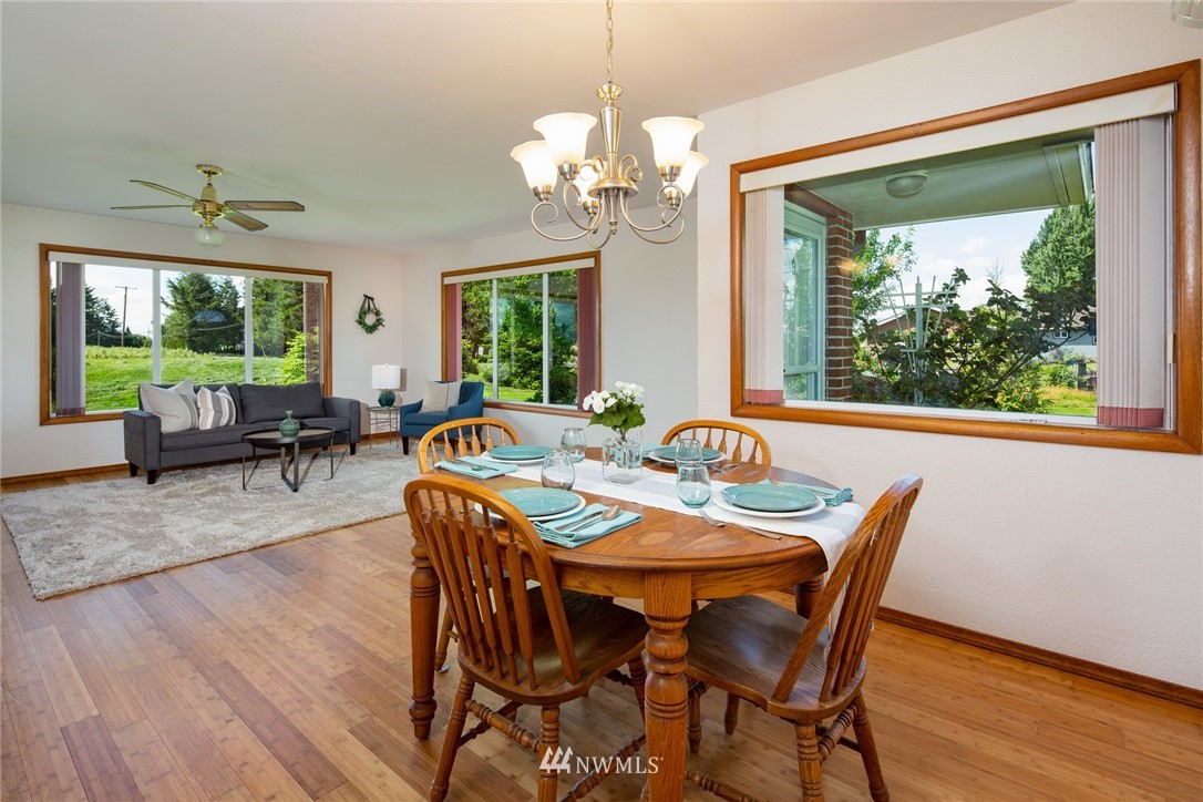1506 Pangborn Road Lynden, WA 98264 - Photo 6 of 40 a view of a dining room with furniture a chandelier and wooden floor