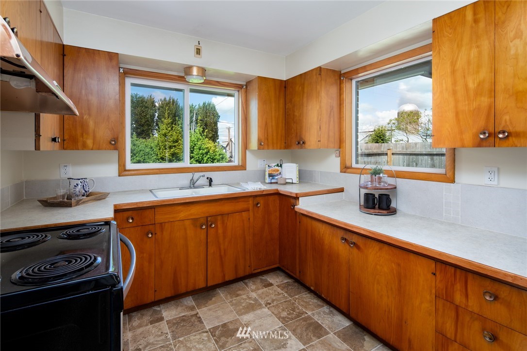 1506 Pangborn Road Lynden, WA 98264 - Photo 7 of 40 a kitchen with stainless steel appliances a sink stove and window