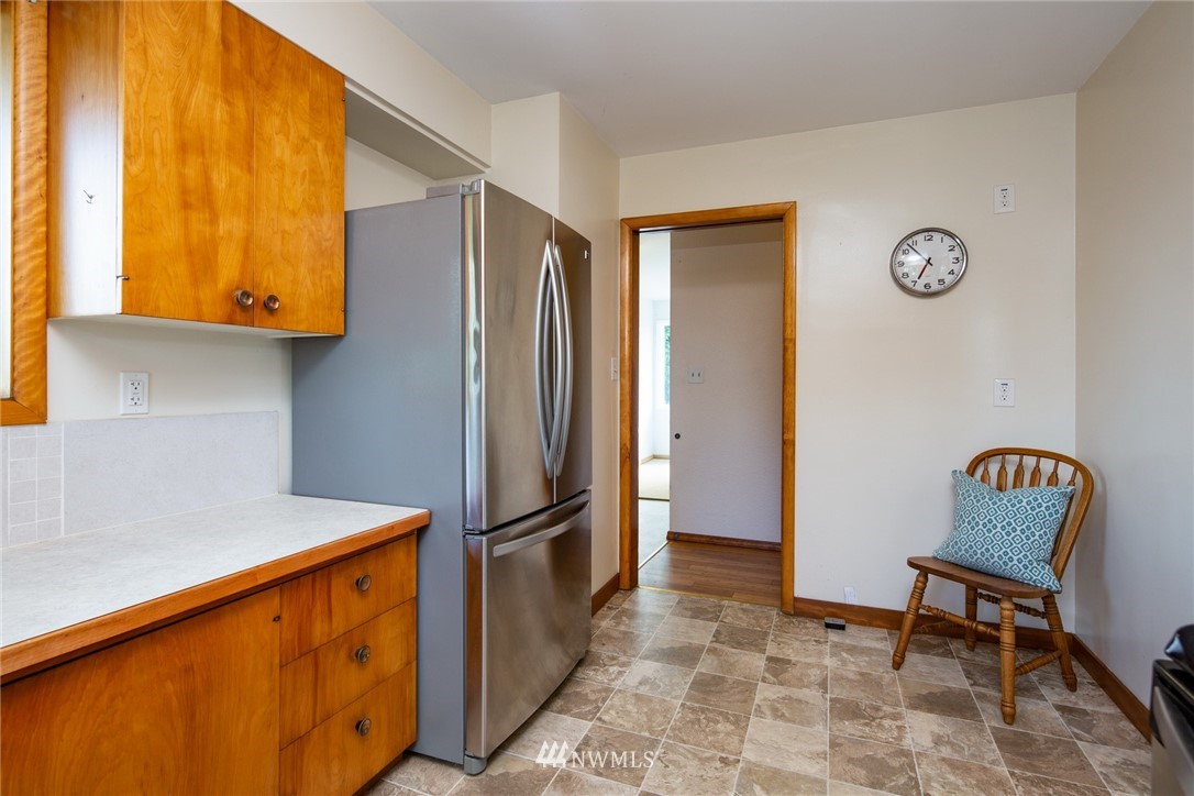1506 Pangborn Road Lynden, WA 98264 - Photo 9 of 40 a kitchen with stainless steel appliances granite countertop a refrigerator and a wooden cabinets