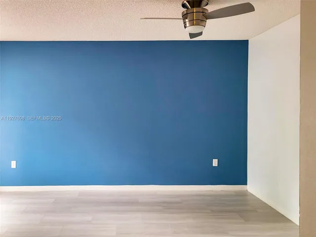 a view of a wall with a ceiling fan