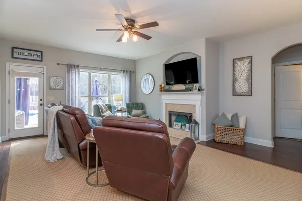 a living room with furniture a fireplace and a flat screen tv