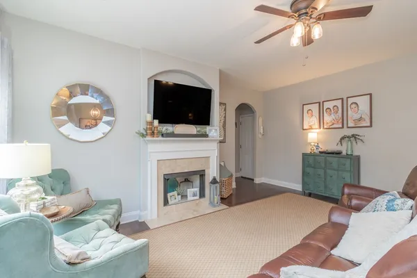 a living room with furniture a flat screen tv and a fireplace
