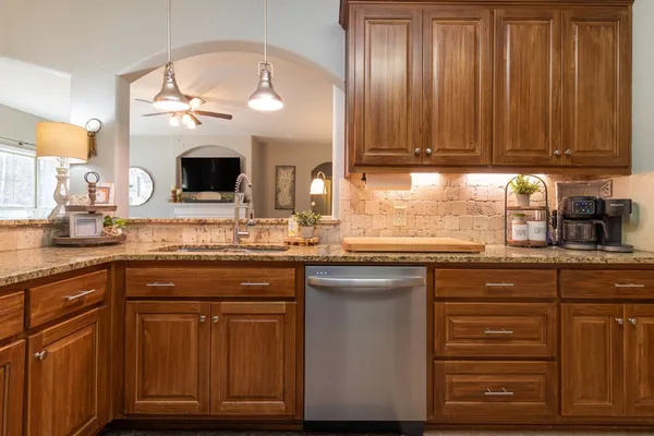 a kitchen with cabinets a sink and appliances