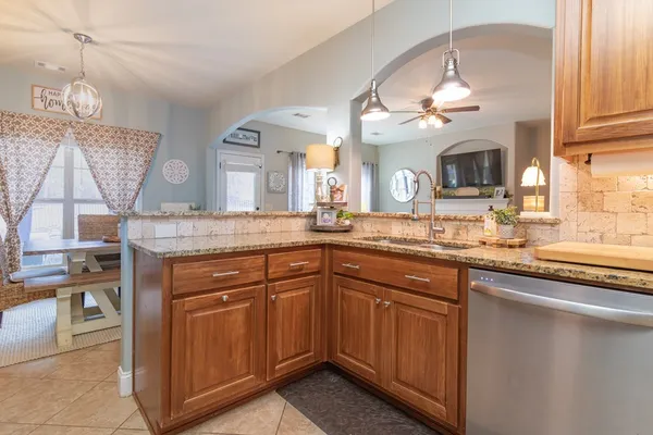 a bathroom with a granite countertop sink a mirror and cabinets