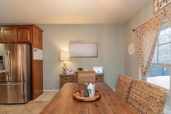 a kitchen with stainless steel appliances kitchen island a table and chairs